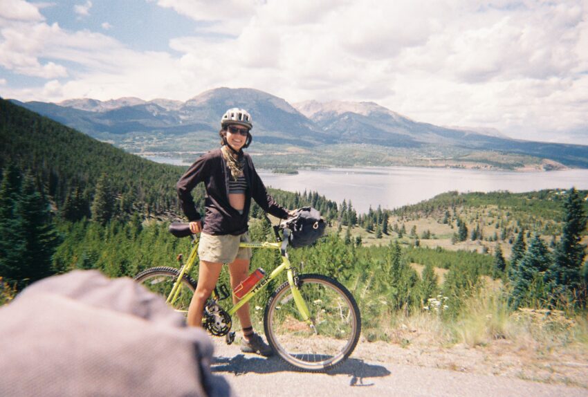 Corinne Persinger doing environmental philosophy while riding a bike in the mountains.